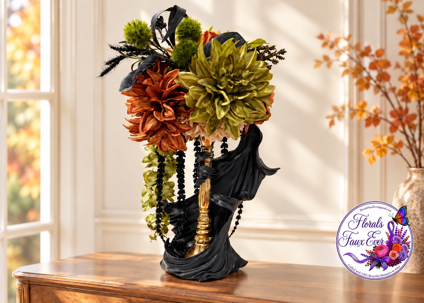 Elegant dark figure arrangement with olive and rust flowers